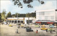 Yaoundé, place de la cathédrale, le magasin Printania. – En 1958, le « Printania » de Yaoundé est la seconde grande surface à ouvrir au Cameroun, un an après le Monoprix de Douala et un avant le Printania de cette même ville. Cette enseigne a été créée en 1952, par un pilier de la distribution en Afrique, la SCOA (Société commerciale de l’Ouest Africain), en association avec Le Printemps. Pour dynamiser le commerce dans les capitales d’AOF et d’AEF, cette même société lance également une autre chaine avec le groupe Prisunic, les magasins « Pariscoa ». Cette formule moderne s’adresse en premier lieu à la clientèle européenne des villes, laissant celle des Africains et des « broussards » aux comptoirs, forme traditionnelle du commerce colonial. Le Cameroun connait en la matière un certain dynamisme, avec une intense concurrence entre sociétés commerciales françaises, anglaises et allemandes notamment. Le statut de tutelle sous mandat de la SDN puis de l’ONU implique, en effet, l’égalité des Etats membres et interdit d’établir des tarifs douaniers préférentiels.