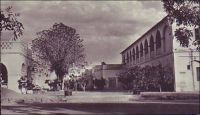Fort-Lamy, le grand hôtel. – « Le ralliement au Général de Gaulle, le transport de la guerre en Afrique, le mouvement des troupes, les échanges commerciaux ont amené en six mois une population européenne abondante : Officiers, Intendance, services, banque, office de changes, administrations diverses, transports, sans compter que ce poste [Fort-Lamy], nu en 1900, est aujourd’hui peuplé de 20.000 indigène et d’une population flottante, indiscernable. […] on construit un marché, un hôtel, un camp, des cases de passage… » Source : Lapie, Pierre Olivier, Mes tournées au Tchad, Londres, John Murray, 1941.