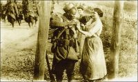 Vendangeuse offrant du raisin à un blessé Sénégalais. - 212 000 Africains, de toute l’AOF, prirent part en tant que tirailleurs sénégalais aux hostilités de la Grande guerre, dont 165 000 sur le sol métropolitain. 30 000 furent tués. Le corps des tirailleurs sénégalais avait été créé en 1857 par Louis Faidherbe, alors gouverneur général de l’AOF, pour palier, en cette époque de conquête coloniale, le déficit de troupes venant de Métropole. Initialement composée d’esclaves rachetés à leurs maîtres africains et affranchis,  et de volontaires issus des élites locales, les régiments de tirailleurs sénégalais s’apparentent à des troupes mercenaires. Mais la mobilisation de tous les Africains de plus de 18 ans décidée en 1915, et l’engagement pour défendre la Nation vont en faire un corps d’engagés et de conscrits des plus légitimes. 17 régiments de tirailleurs sénégalais participent à la bataille de la Somme, subissant d’importantes pertes qui vaudront au Général Mangin, par ailleurs promoteur des troupes africaines, le surnom de « boucher des noirs ».